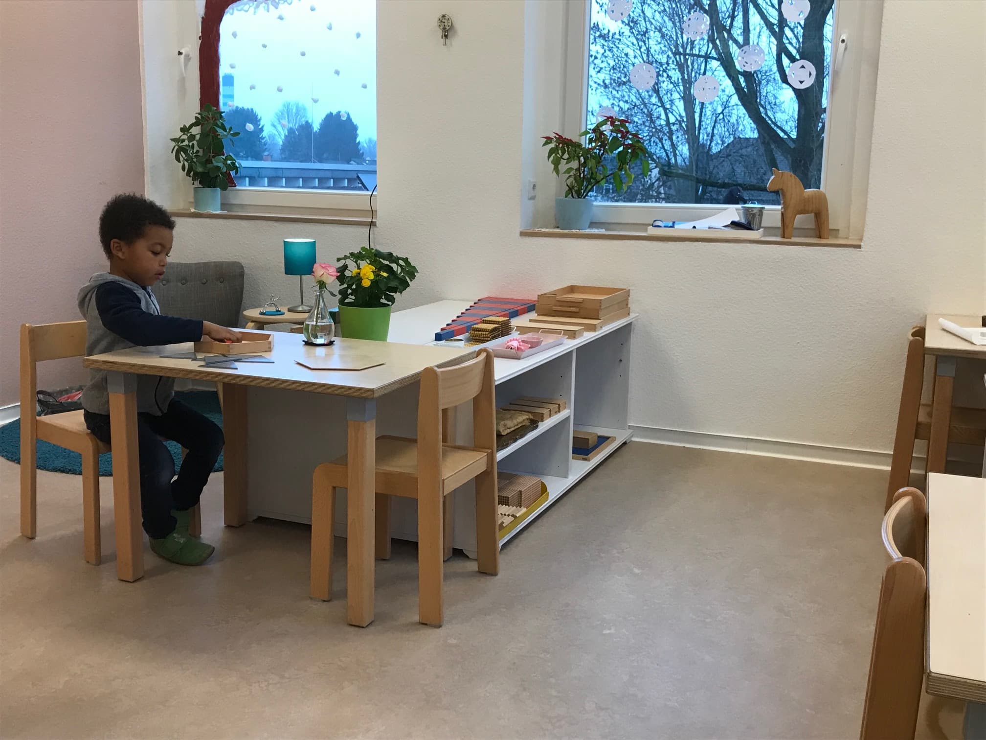 A Child working alone at a table in a prepared environment