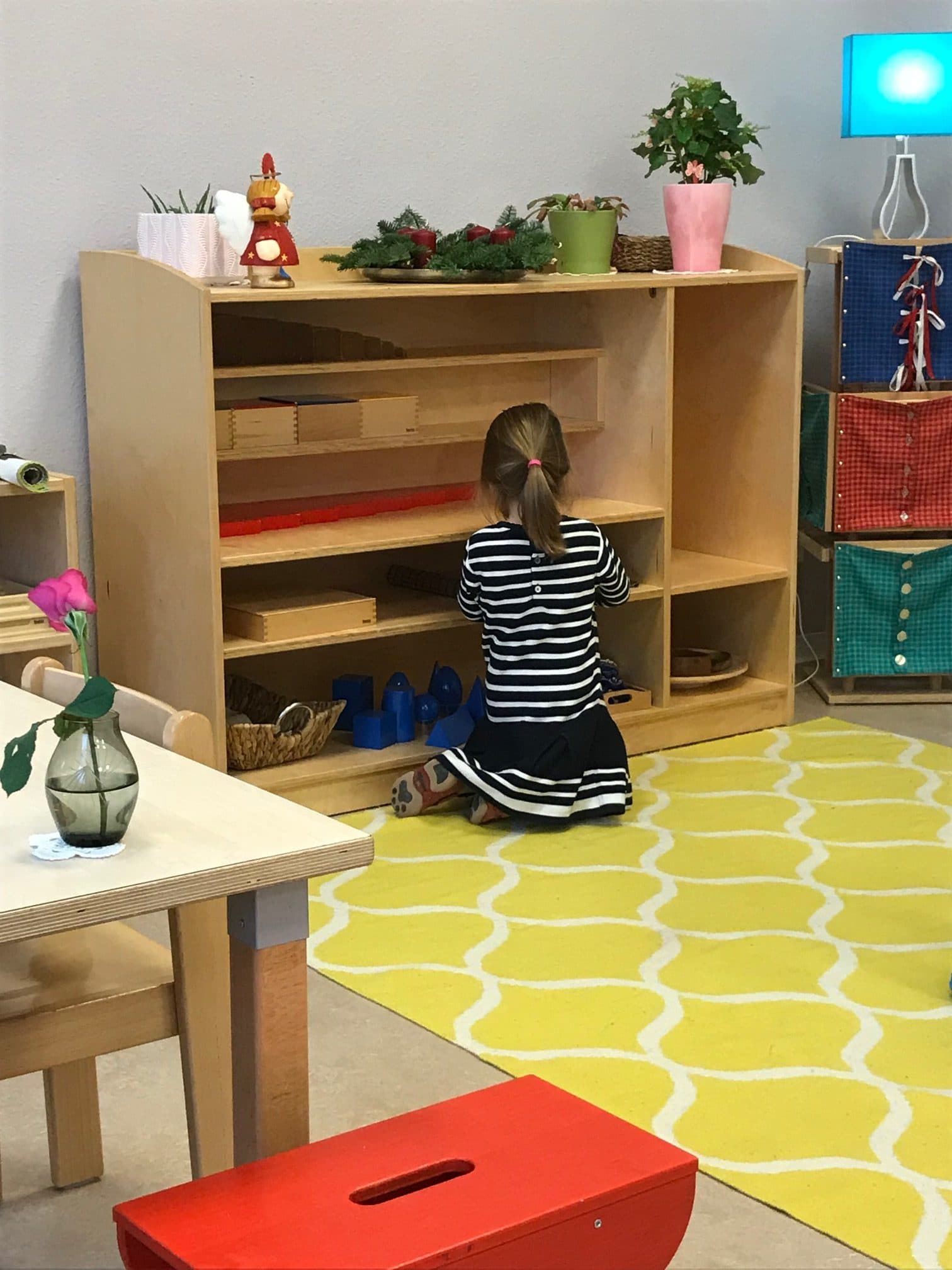 A Child choosing work from a shelf