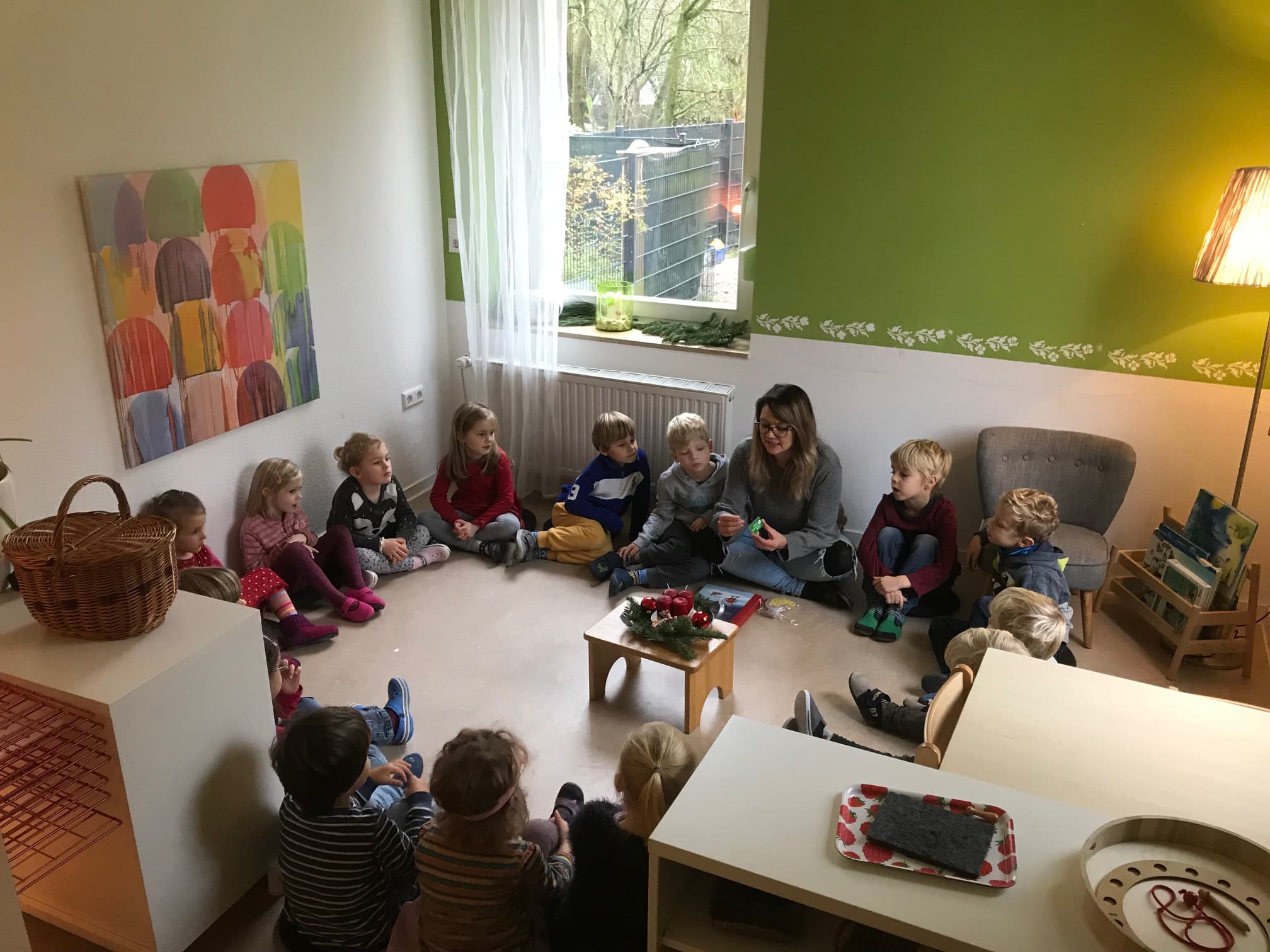 A Guide sitting with a group of Children